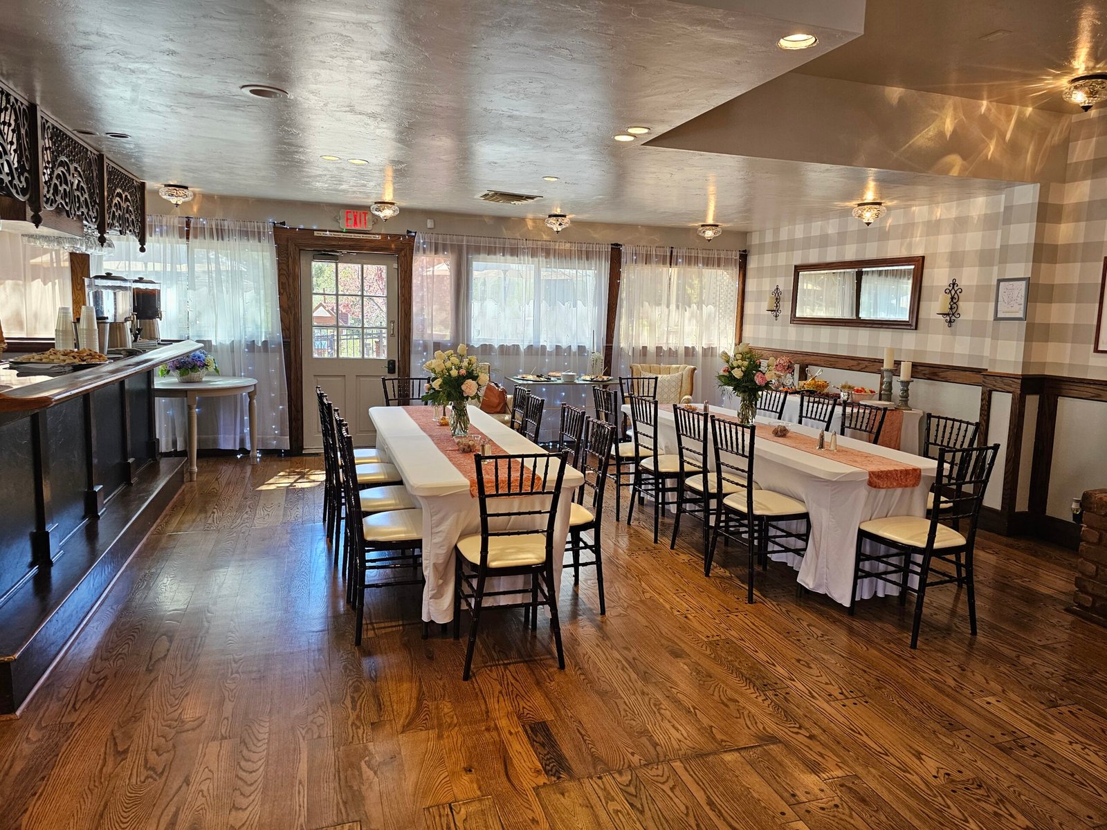 Rustic indoor dining room with long tables and hardwood floors at Willow Creek Inn.