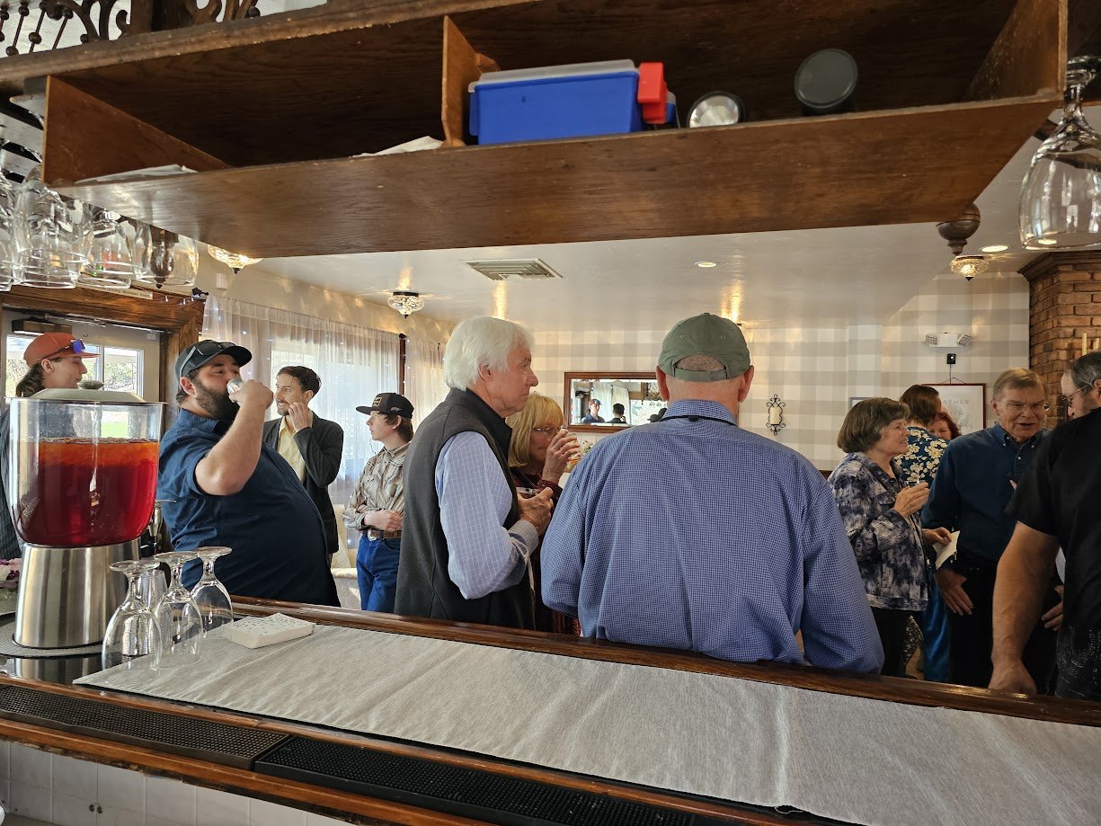 Guests gathering at an outdoor event near the historic Victorian building at Willow Creek Inn in Prescott, Arizona.
